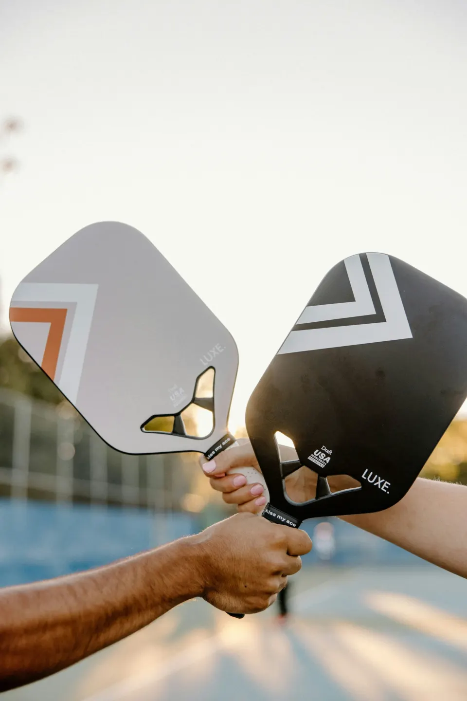 Two paddles raised together before a match